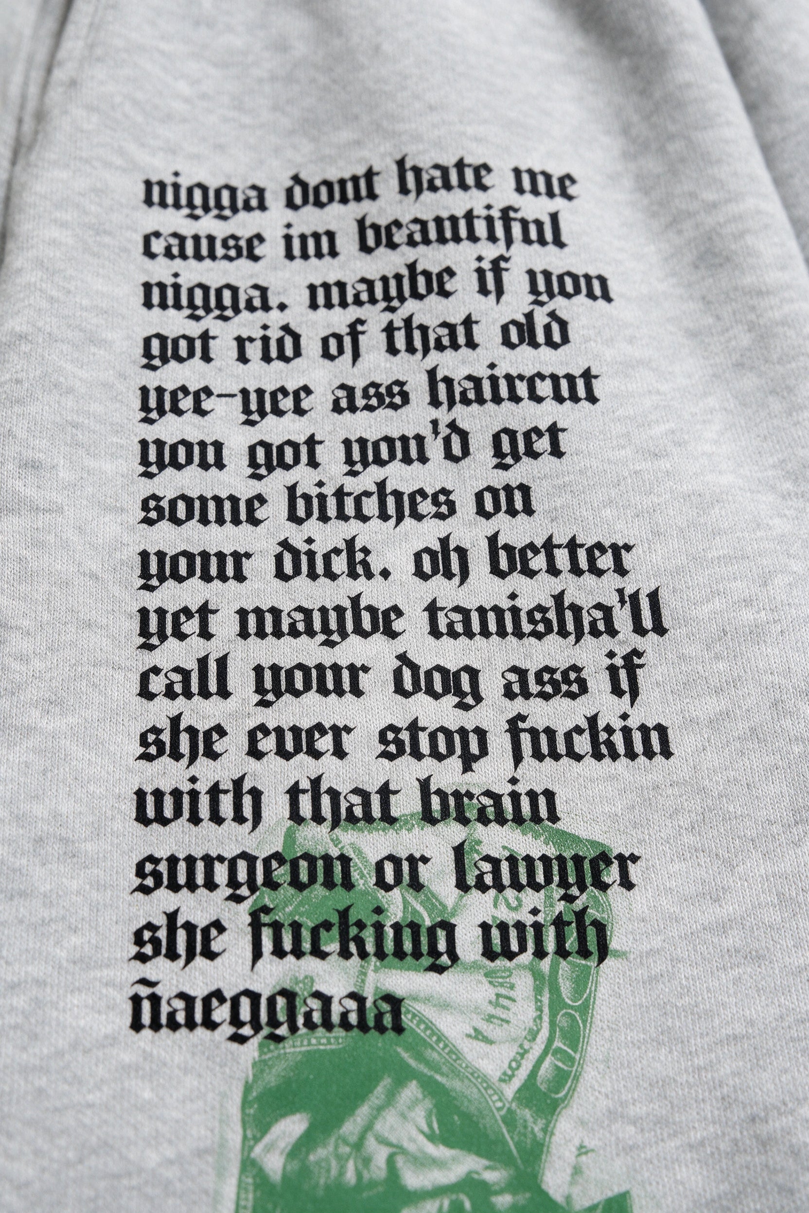 Los Santos text artwork detail on grey sweatpants